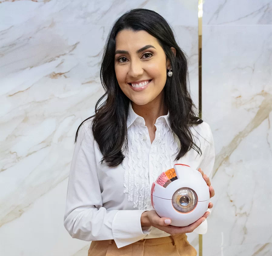 Dra. Beatriz Alves segurando um modelo anatômico do olho